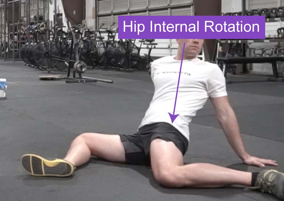 A picture of a man on the ground demonstrating hip joint internal rotation